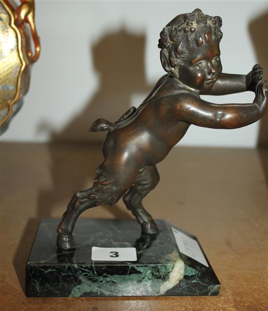 Metal figure of a cherub faun